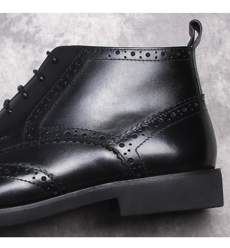 Black wingtip lace-up dress boots with stitched panels and padded collar