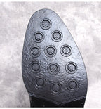 Black thick-sole boot outsole with circular traction pattern