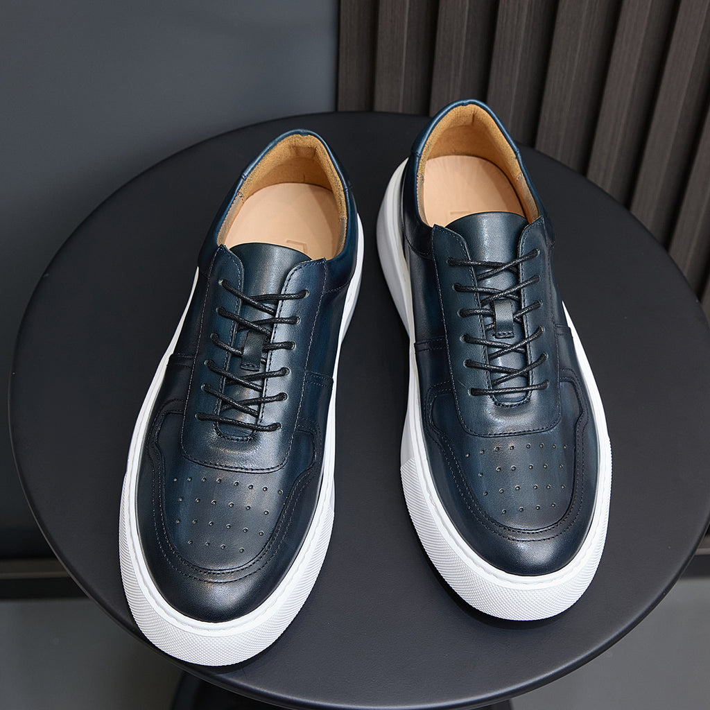 Men's navy leather lace-up sneakers with white rubber sole and perforated toe