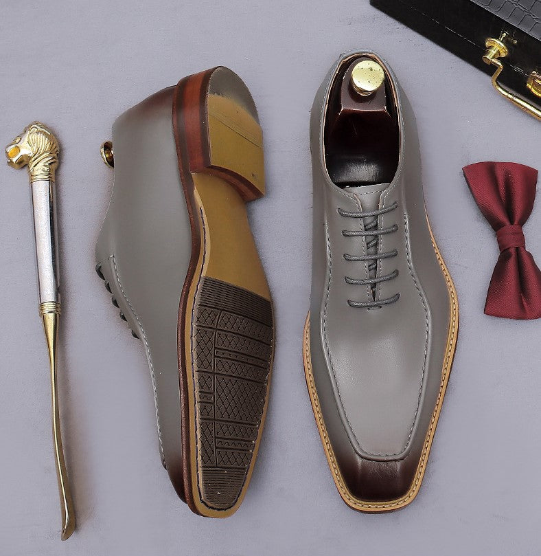 Gray chunky lug-sole brogue Oxford shoes with dark brown outsole, lace-up side view