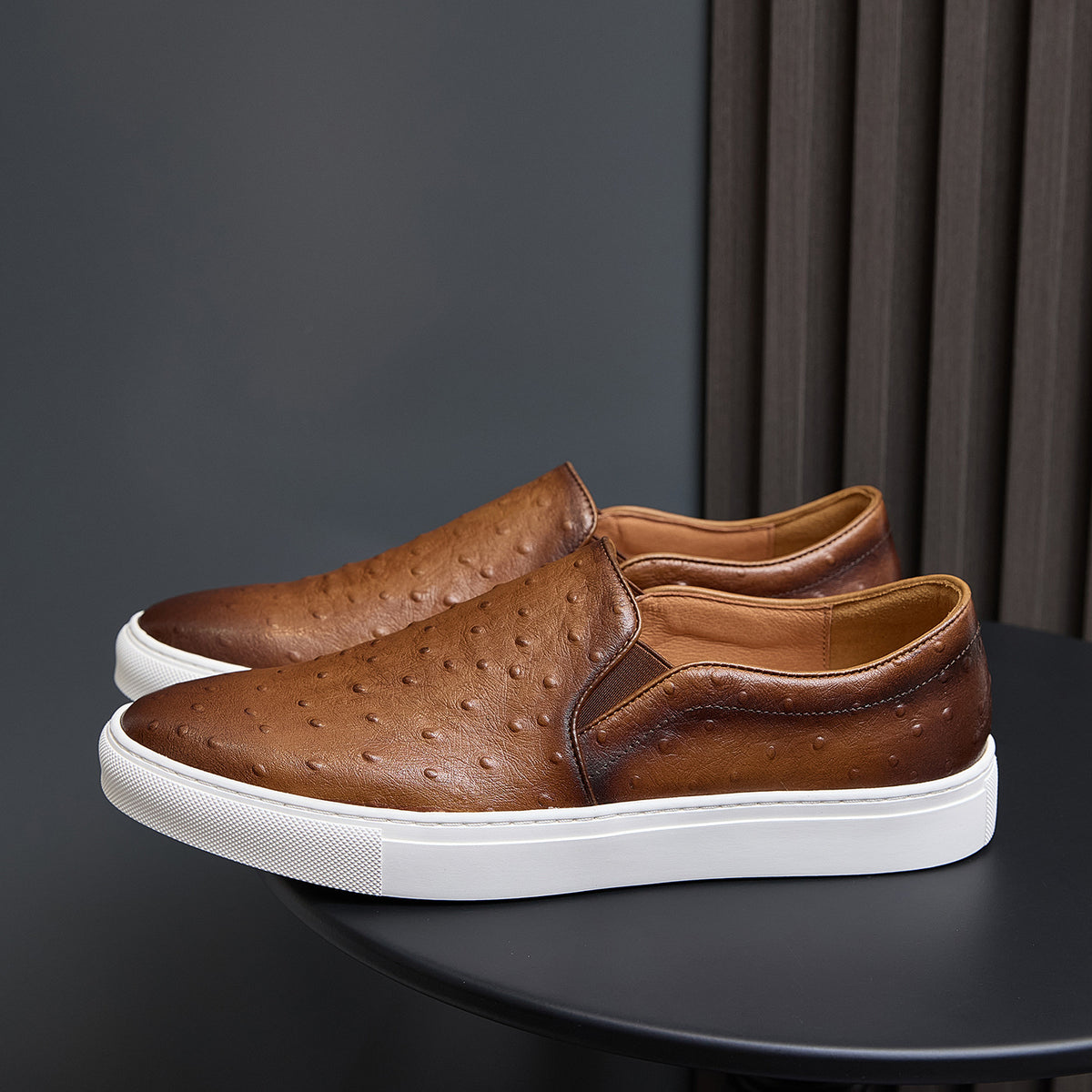 Men's brown leather slip-on sneakers with perforated upper and white rubber sole