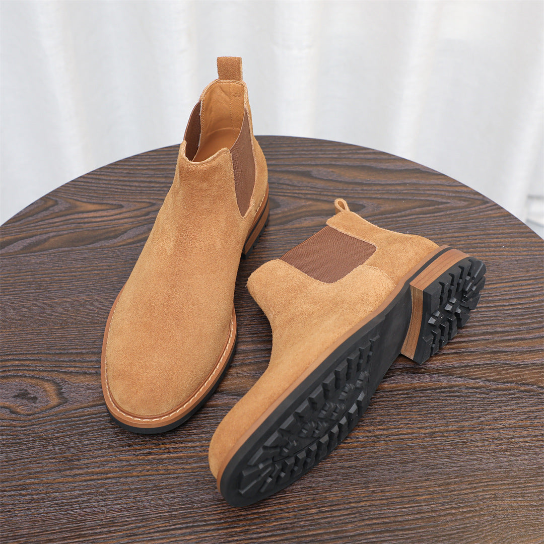 Tan suede Chelsea boots with elastic gore and chunky rubber outsole with tread.