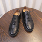 Men's black leather sneakers, pair view with tan-lined interior and lace-up