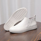 White leather ankle boots with side zipper and textured sole tread