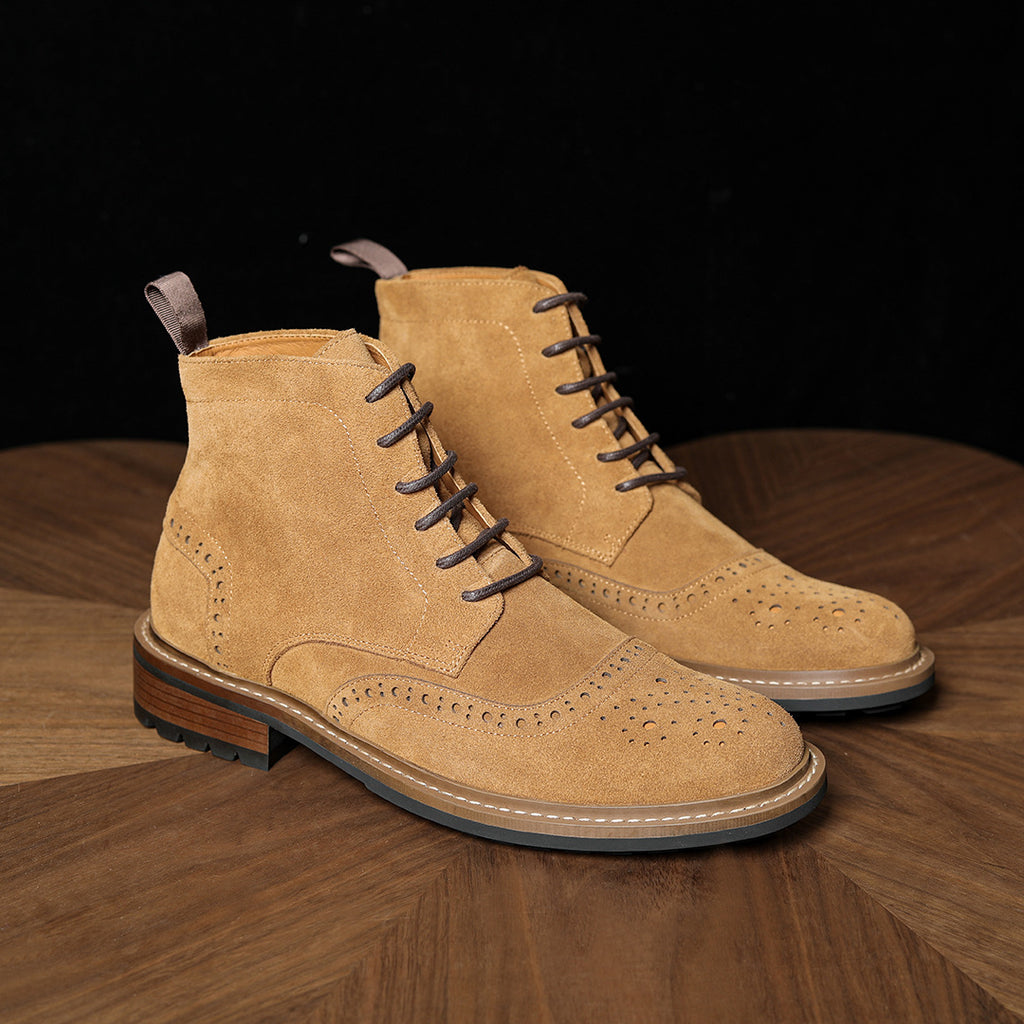 Tan suede chukka boots with lace-up design, perforated panels, light midsole and rubber outsole