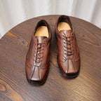 Men's brown leather sneakers with lace-up front and cushioned tongue