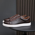Dark brown leather low-top sneakers, lace-up design, white rubber sole