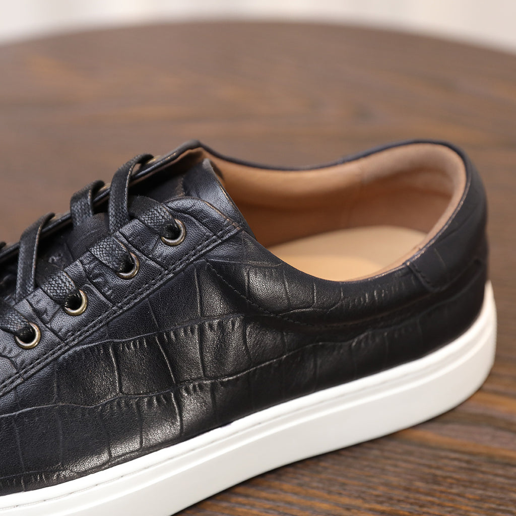 Men's black genuine leather sneakers, lace-up with padded collar and white sole.