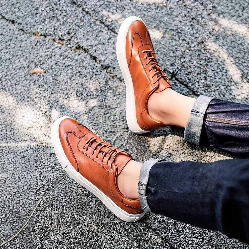 Brown leather lace-up sneakers with white rubber sole and textured outsole