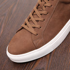 Brown suede leather sneaker with lace-up front and white rubber sole detail