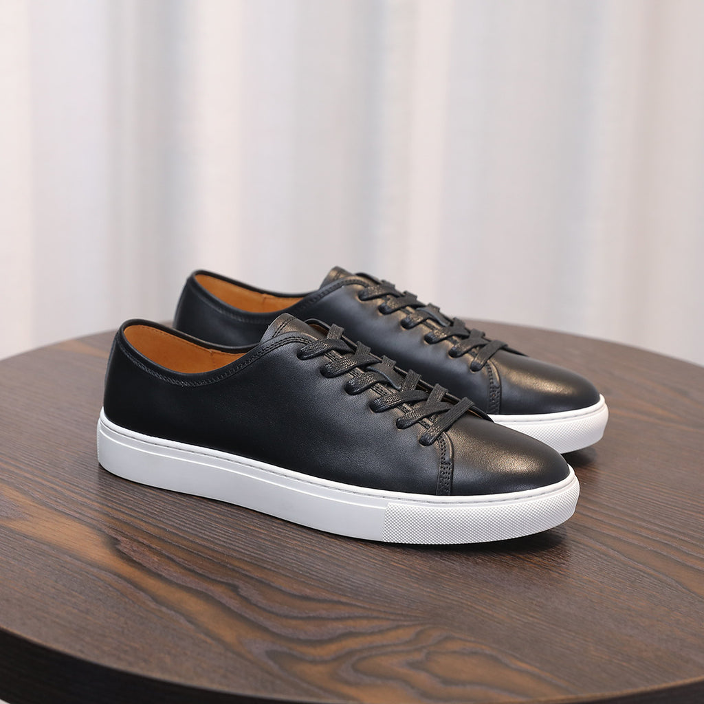 Black leather lace-up sneakers with white midsole, side profile.