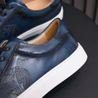 Men's blue leather sneakers with embossed side pattern and white rubber sole