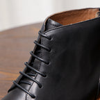 Black leather boot upper with lace-up design and visible stitching detail