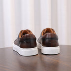 Dark brown genuine leather sneakers, lace-up with white sidewall and padded collar