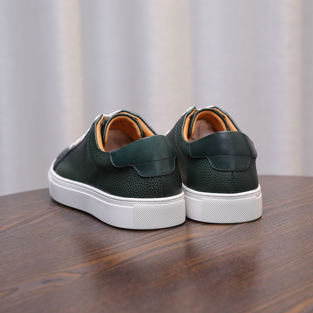 Back view of green leather sneakers with padded heel and white rubber sole