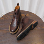 Dark brown leather chukka boots with lace-up front and thick rubber outsole tread