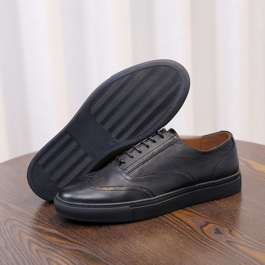 Men's black leather sneakers with textured rubber sole and lace-up upper