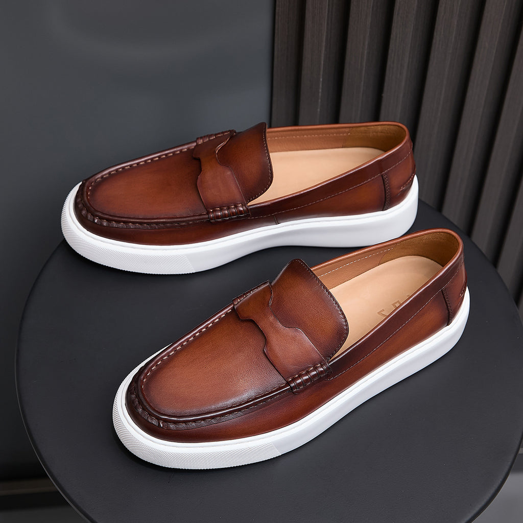 Men's brown leather slip-on sneakers with white rubber sole and side stitching detail.
