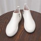 White leather side-zip ankle boots with pointed toe and white platform sole