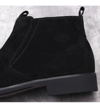 Black suede side-zip ankle boot with thick sole, showing side panel seams.