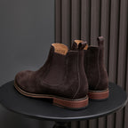 Back view of pointed-toe suede Chelsea dress boots, dark brown, showing heel and elastic goring