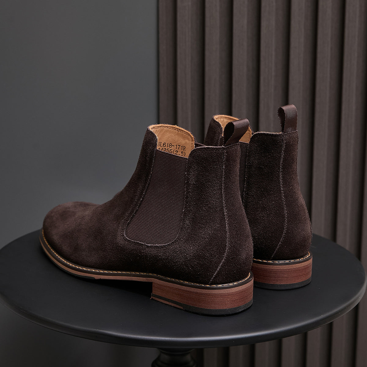 Back view of pointed-toe suede Chelsea dress boots, dark brown, showing heel and elastic goring