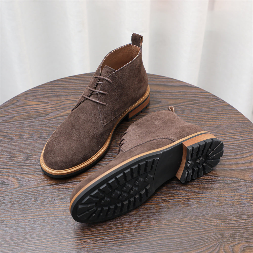 Dark brown lace-up chukka boots with tread outsole, angled side and bottom view.
