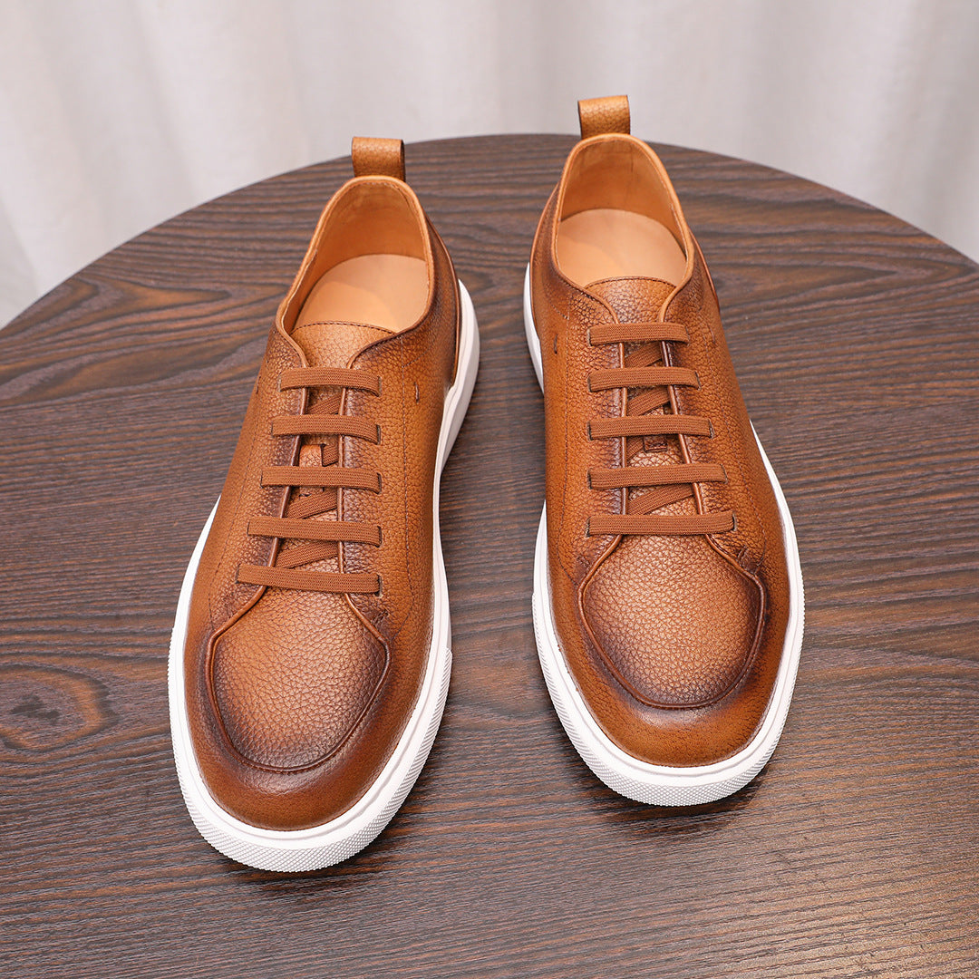 Brown leather low-top sneakers with lace-up front and white rubber sidewall