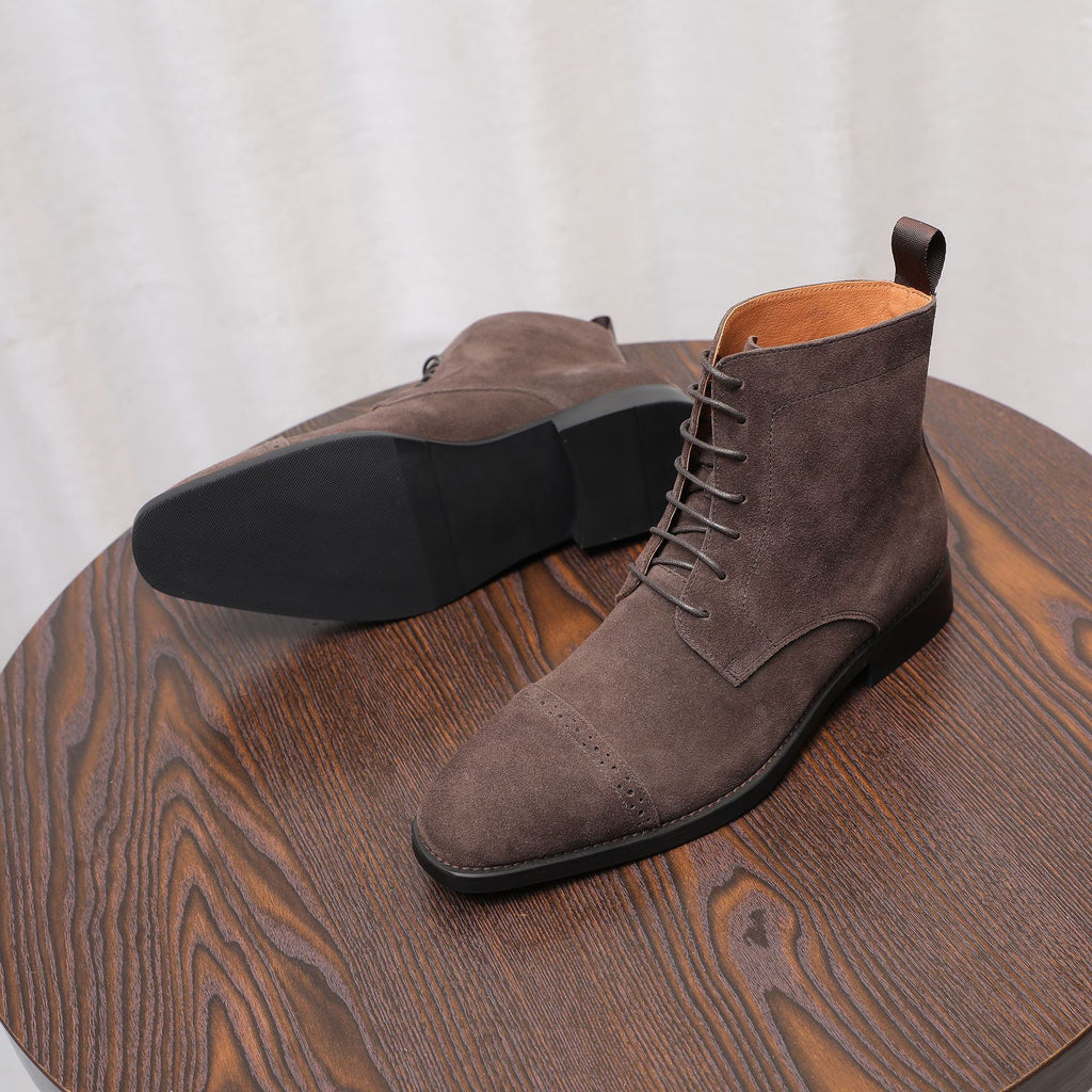 Dark brown suede chukka boots with lace-up front, cushioned collar, and black outsole