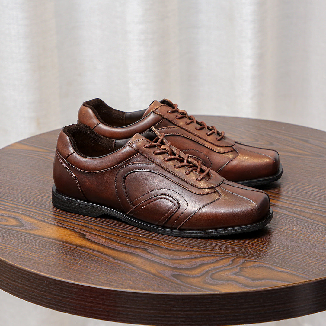 Men's brown leather sneakers, side view with stitched panels and lace-up closure