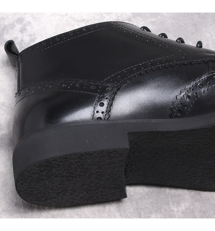 Black lace-up dress boots with chunky sole and wingtip detailing