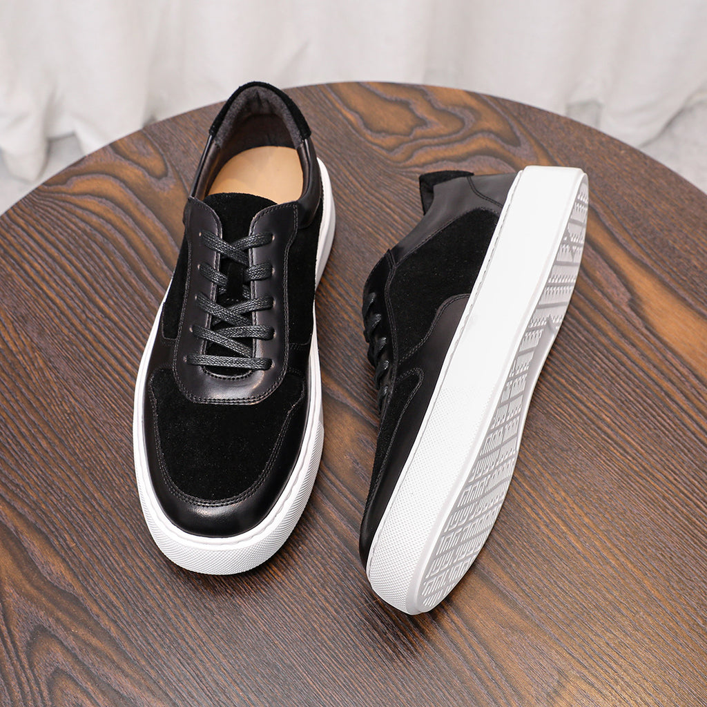 Black leather lace-up sneakers with white rubber sole and low-profile side panels