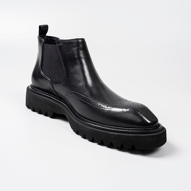 Black leather Chelsea dress boot with elastic side panel and brogue-style perforations