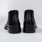 Black genuine leather chelsea dress boots, rear view with stacked heel