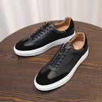 Men's black leather low-top sneakers with laces and white rubber sole platform