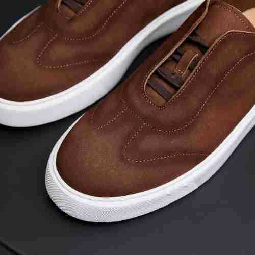 Brown leather low-top sneakers with lace-up panel and white rubber sidewall