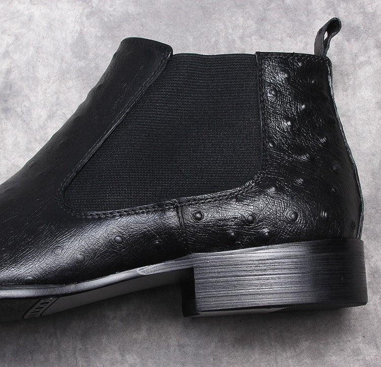 Black leather Chelsea boots close-up of elastic gore and textured leather