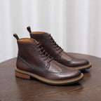 Dark brown leather lace-up chukka boots with plain toe and brogue-style perforations