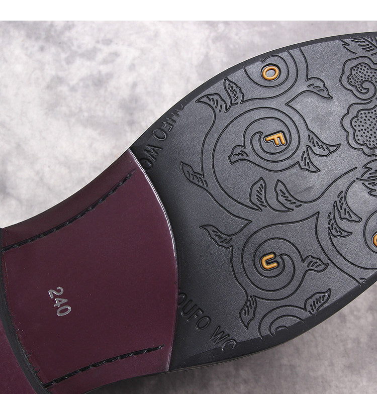 Black Chelsea boot outsole with patterned tread and stitched edge detail