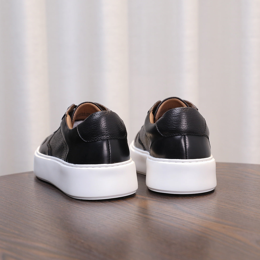 Black leather sneakers rear view with lace closure, padded heel, and white sole