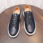 Pair of dark blue leather lace-up sneakers with white rubber sole