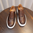 Men's brown leather sneakers with lace-up front and white sidewall sole