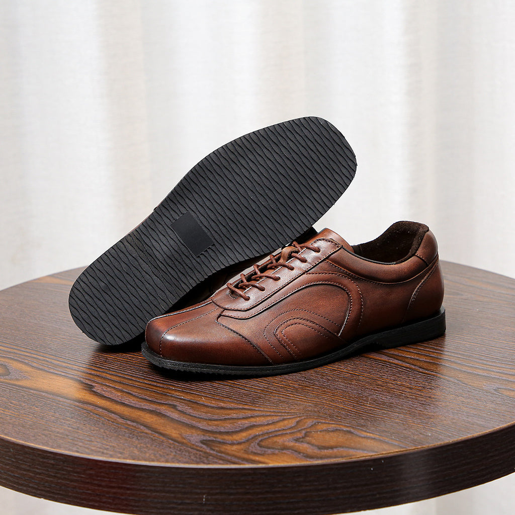 Men's brown leather sneakers with black textured outsole and low-profile sole