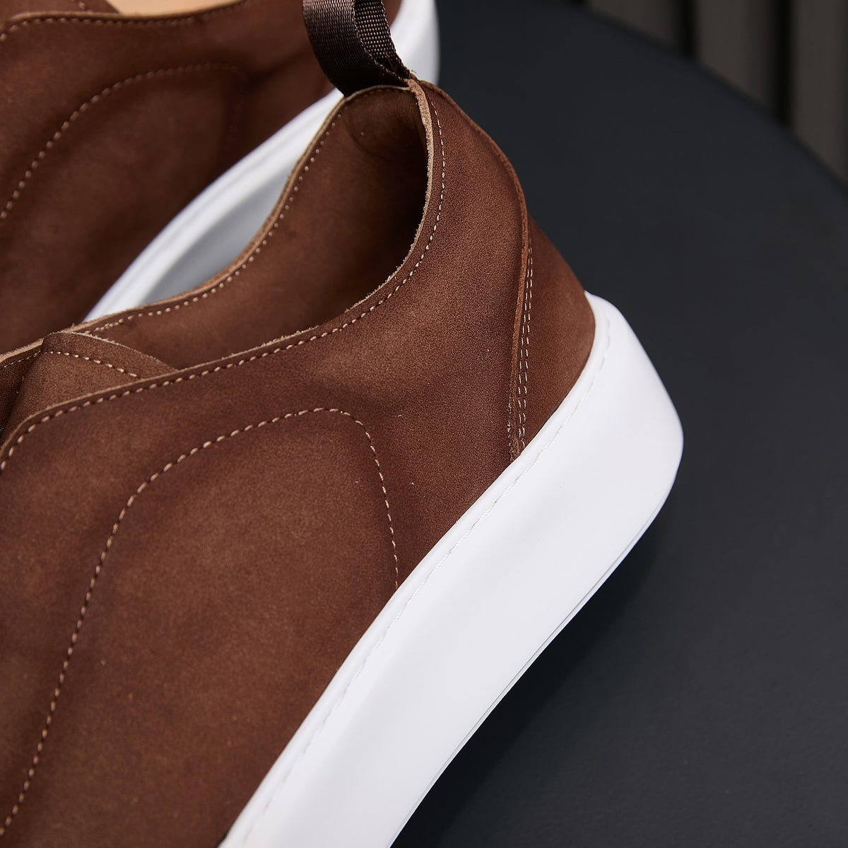 Brown suede leather sneakers with side stitching, elastic-look collar, and white sole
