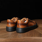Brown genuine leather sneakers, rear view with padded collar and chunky rubber sole