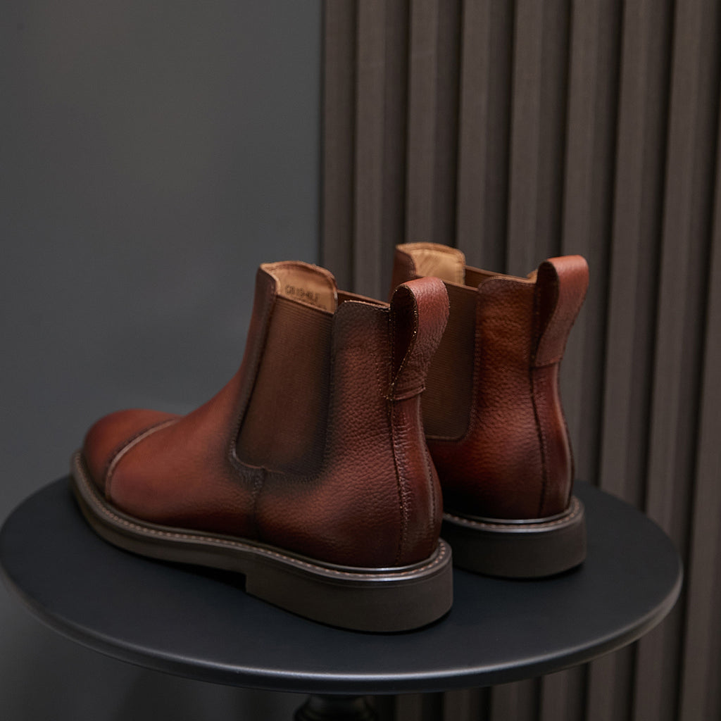 Back view of brown Chelsea dress boots with elastic inserts and pull-on loops.