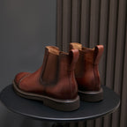Back view of brown Chelsea dress boots with elastic inserts and pull-on loops.