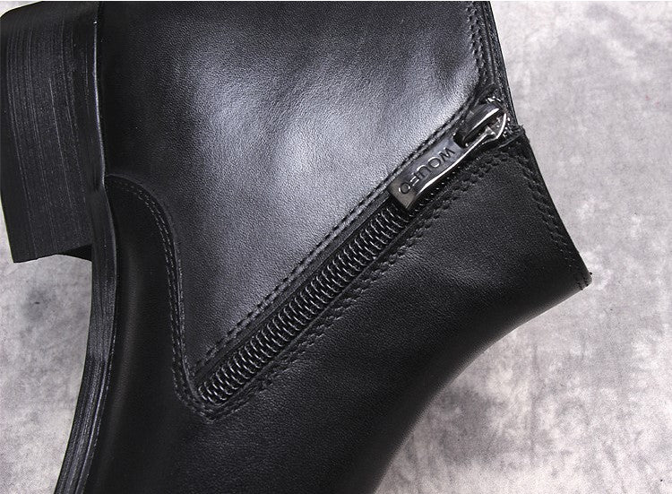 Black leather side-zip detail with metal zipper pull on thick sole dress boot.