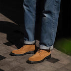 Men's tan lace-up chukka boots with thick rubber sole, side view