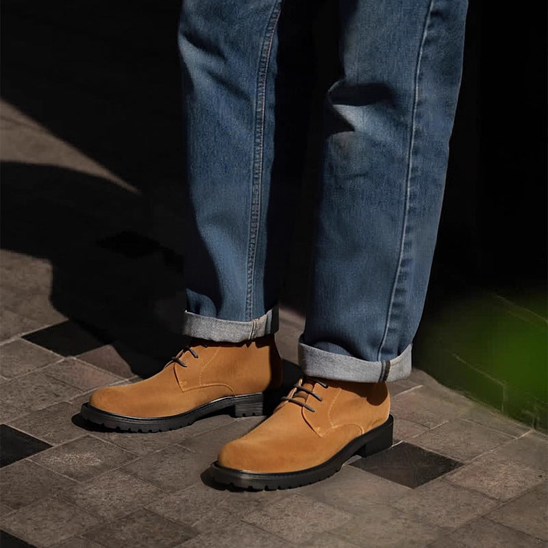 Men's tan lace-up chukka boots with thick rubber sole, side view